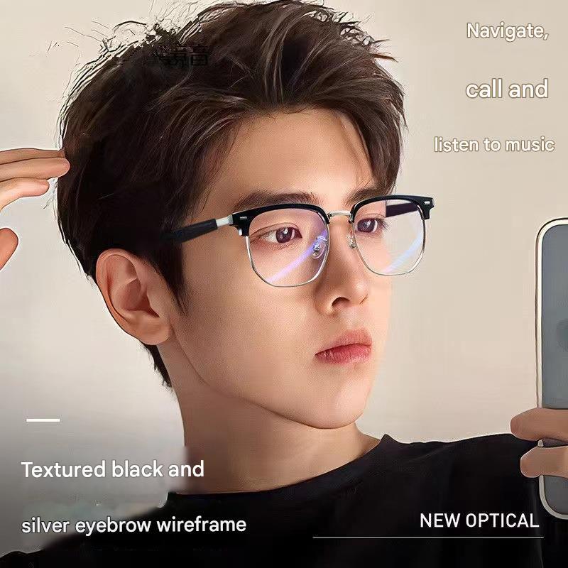 Young man wearing textured black and silver eyebrow wireframe glasses, holding smartphone
